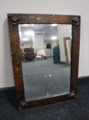 An Art Nouveau copper framed mirror