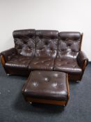 A mid 20th century teak G Plan saddle suite in brown button fabric with footstool