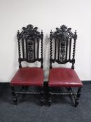 A pair of heavily carved oak barley twist chairs