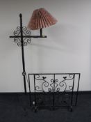 A wrought iron standard lamp with shade,