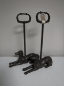 A pair of cast metal dog door stops
