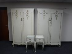 A pair of cream and gilt double door wardrobes and a pair of bedside stands