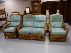 A three piece bamboo and wicker conservatory suite