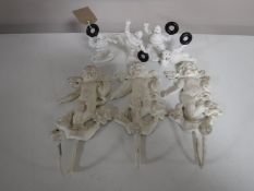 Four cast metal Michelin Man figures,