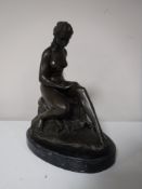 A bronze figure of a nude female on marble base