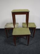 A set of four mid 20th century teak upholstered footstools