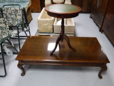 A contemporary mahogany coffee table on Queen Anne legs,