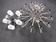 A chrome twelve branch chandelier and a five branch chandelier with glass shades