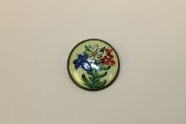 A silver and enamel brooch