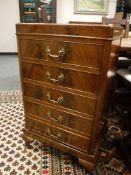 A mahogany five drawer music cabinet,