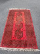 A fringed Bokhara rug CONDITION REPORT: This measures 200cm by 109cm.