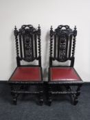 A pair of heavily carved oak barley twist chairs