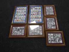 Seven frames containing Players and Wills cigarette cards,