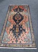 A fringed Persian rug of geometric design