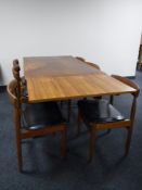 A mid 20th century teak extending table and six chairs