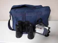 A bag containing a Canon video camera, two sets of cased binoculars,