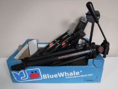 A box containing a camera tripod together with four folding guitar stands by Q-EX and Stagg