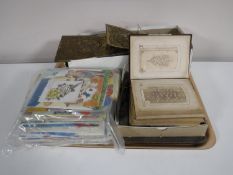 A tray containing an antique leather bound photo album,