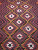 An Afghan kilim style fringed rug 2m x 2.