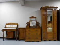 A four piece Edwardian satin walnut bedroom suite, comprising of mirror door wardrobe,