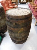 A coopered oak barrel CONDITION REPORT: This measures 89cm high and 60cm in diameter.