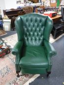 A green button leather Chesterfield style wingback reclining armchair