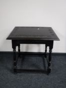 A carved oak occasional table