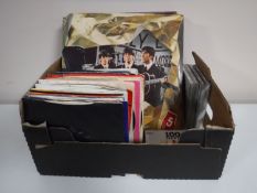 A box containing LP's, 45's and CD's, including The Beatles, Stevie Wonder, Madonna,