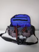 A camera bag containing a Praktica MTL3 camera with lens and accessories