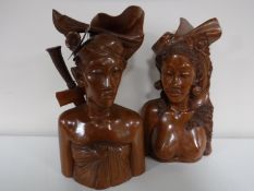 A pair of Bali carved hardwood busts depicting a lady and man