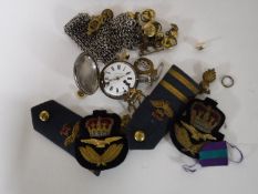 A box containing military buttons and patches,