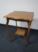An Edwardian oak two tier occasional table