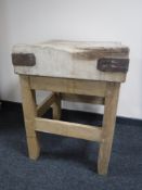 An antique pine butcher's block on stand