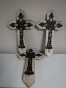 Four cast metal crosses,