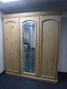 A Victorian pine triple door wardrobe