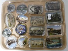 A tray of sixteen early/mid 20th century glass tourist paperweights