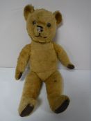 A vintage jointed teddy bear