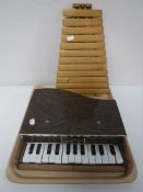 A miniature grand piano and a wooden xylophone