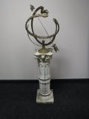 A brass sundial on a concrete column support