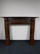 A mahogany carved fire surround