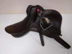 A leather saddle with stirrups