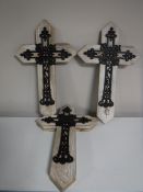 Four cast metal crosses,