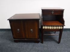 An inlaid mahogany double door cabinet and a mahogany telephone table