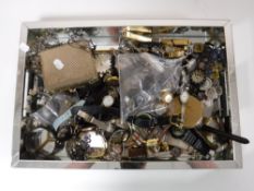 A mirrored tray containing a large quantity of assorted wrist watches, costume jewellery, purse,