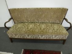 A mid 20th century walnut framed settee in gold brocade