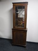 An inlaid mahogany Regency style display cabinet fitted a cupboard beneath