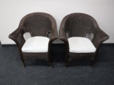A pair of wicker conservatory armchairs