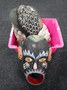 A box containing wooden tribal masks