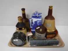 A tray containing Bells scotch whiskey decanters, a cased Royal Navy ships compass,