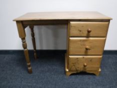 A pine dressing table fitted three drawers
